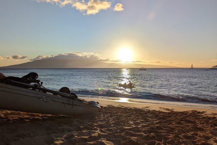 a sandy beach next to a body of water