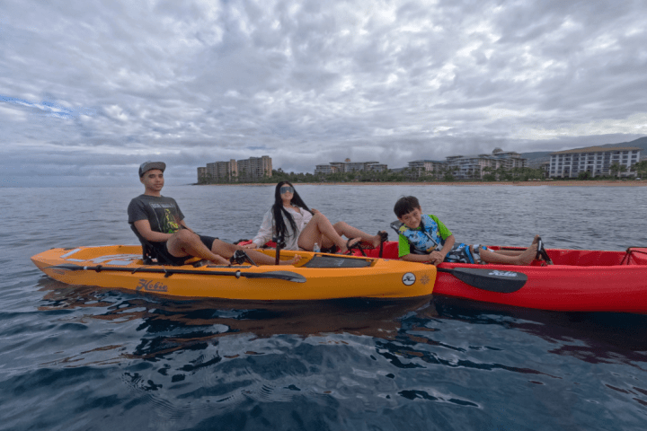 a group of people in a small boat in a body of water