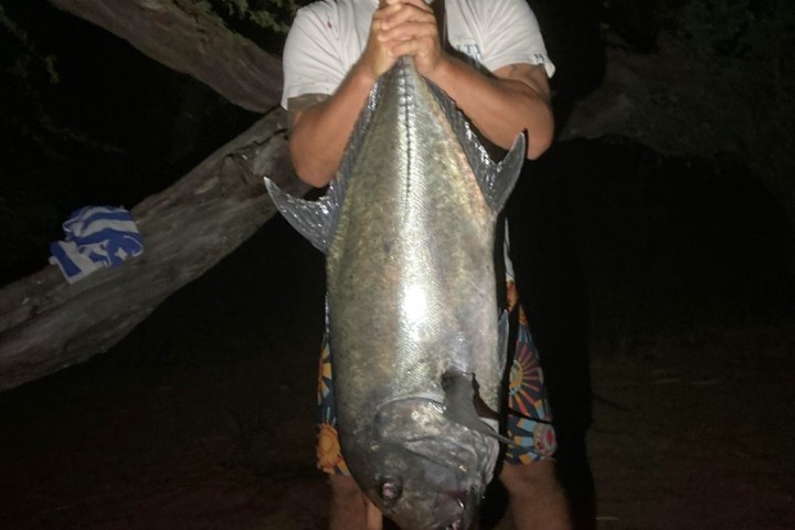 a man holding a fish